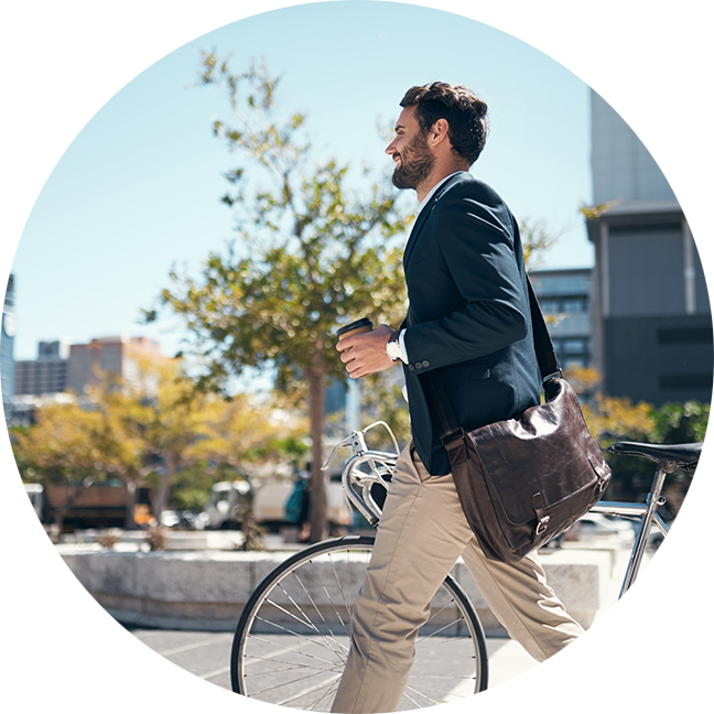 Man walking with his bike in the city