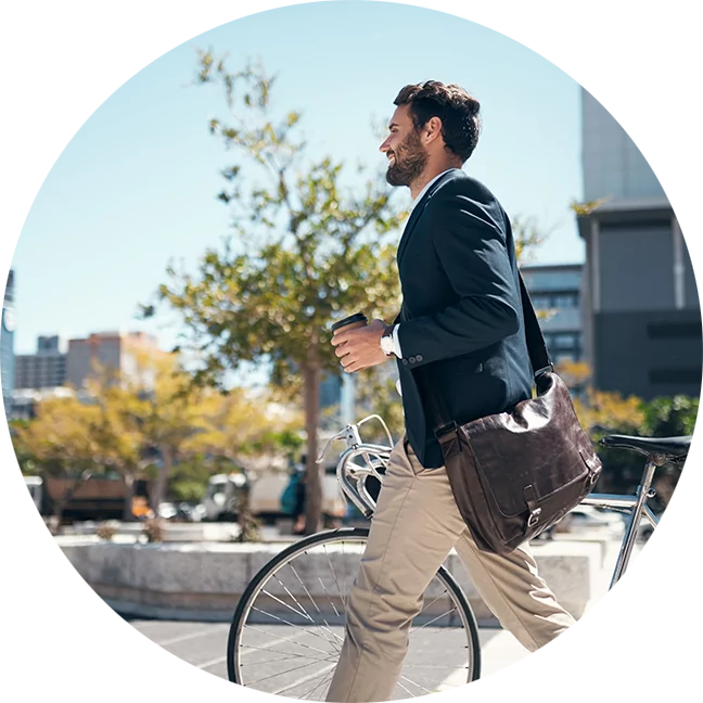 Man walking with his bike in the city