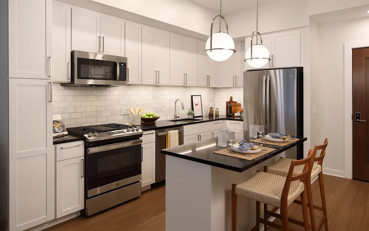 The Milton at Twinbrook Quarter one bedroom kitchen with white cabinets and center island